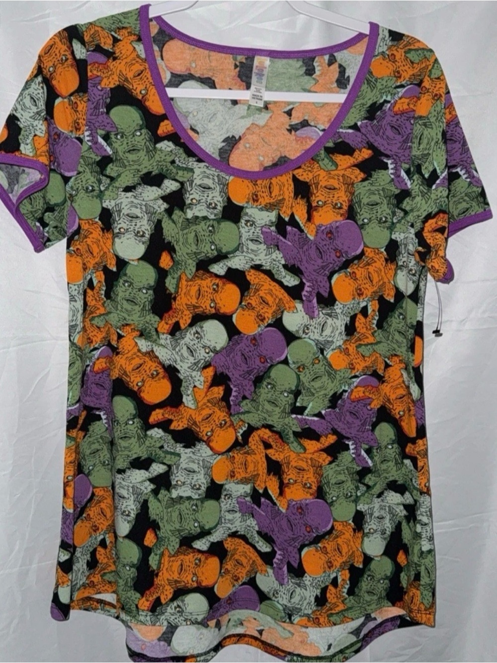 LuLaRoe Short Sleeve Tee in Black, Orange, Green, Purple creature black lagoon